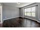 Bright bedroom featuring large window, dark hardwood floors, and neutral walls at 2001 Laurel Village Cir, Belmont, NC 28012