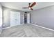 Bedroom features neutral gray walls, plush carpeting, a ceiling fan, and double door closet at 2001 Laurel Village Cir, Belmont, NC 28012