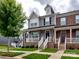 Inviting townhouse exterior with a front porch, stone accents, neat landscaping, and sidewalk appeal at 2001 Laurel Village Cir, Belmont, NC 28012
