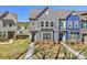 Charming townhome with gray siding, black awnings, manicured landscaping, and a well-maintained lawn at 2001 Laurel Village Cir, Belmont, NC 28012