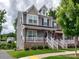 Charming two-story home with a welcoming front porch, gray siding, and well-maintained landscaping at 2001 Laurel Village Cir, Belmont, NC 28012