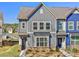 Charming townhome featuring modern gray siding and well-manicured landscaping and inviting curb appeal at 2001 Laurel Village Cir, Belmont, NC 28012