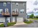 Modern townhome featuring a private balcony, a garage, and an attached driveway at 2001 Laurel Village Cir, Belmont, NC 28012