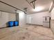 Clean garage featuring a concrete floor, utility cabinet, and an overhead door at 2001 Laurel Village Cir, Belmont, NC 28012