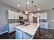 Bright and modern kitchen with white cabinets, a center island, and stainless steel appliances, perfect for cooking at 2001 Laurel Village Cir, Belmont, NC 28012
