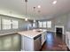 Modern kitchen island with stainless steel appliances, pendant lighting, and hardwood floors in open layout at 2001 Laurel Village Cir, Belmont, NC 28012