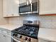 Updated kitchen featuring stainless steel gas range, microwave, and white subway tile backsplash at 2001 Laurel Village Cir, Belmont, NC 28012