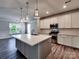 Open concept kitchen with a large island, stainless appliances, and views to the adjacent dining area at 2001 Laurel Village Cir, Belmont, NC 28012
