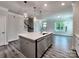Modern kitchen with island sink, pendant lighting, and stainless steel appliances blending style and function at 2001 Laurel Village Cir, Belmont, NC 28012