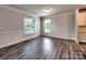 Spacious living room with natural light, gray plank flooring, and modern finishes creating a welcoming atmosphere at 2001 Laurel Village Cir, Belmont, NC 28012