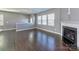 Inviting living room featuring gleaming hardwood floors and a charming fireplace, perfect for relaxation and gatherings at 2001 Laurel Village Cir, Belmont, NC 28012