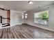 Bright living room featuring wood-look flooring, large windows, and stylish trim throughout the space at 2001 Laurel Village Cir, Belmont, NC 28012