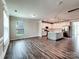 Bright, open-concept living space with plank flooring, and a modern kitchen with stainless appliances at 2001 Laurel Village Cir, Belmont, NC 28012