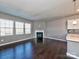 Comfortable living space with a fireplace, hardwood floors, and seamless connection to the kitchen area at 2001 Laurel Village Cir, Belmont, NC 28012