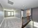 Loft features neutral gray walls, plush carpeting, windows, and a view of the staircase at 2001 Laurel Village Cir, Belmont, NC 28012