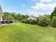 Large backyard featuring a well-maintained lawn, mature trees, and outdoor seating for relaxation and recreation at 2005 Grimley Ln, Fort Mill, SC 29707