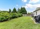 Expansive backyard with lush greenery, privacy landscaping, and patio seating for outdoor enjoyment at 2005 Grimley Ln, Fort Mill, SC 29707