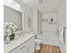 Bright bathroom featuring a vanity, tub, and decorative shelving for a spa-like experience at 2005 Grimley Ln, Fort Mill, SC 29707