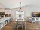 Bright dining area adjacent to the kitchen, featuring a modern chandelier and wood floors at 2005 Grimley Ln, Fort Mill, SC 29707