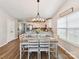 Bright dining area adjacent to the kitchen, featuring a modern chandelier and wood floors at 2005 Grimley Ln, Fort Mill, SC 29707