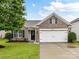 Charming single-Gathering brick home with a well-maintained yard and two-car garage at 2005 Grimley Ln, Fort Mill, SC 29707