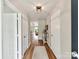 Inviting hallway with wood floors leading to an open-concept living space and plenty of light at 2005 Grimley Ln, Fort Mill, SC 29707