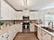 Stylish kitchen with stainless steel appliances, white cabinetry, and a subway tile backsplash at 2005 Grimley Ln, Fort Mill, SC 29707