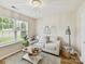 Cozy living room featuring a white sofa, stylish decor, and a decorative light fixture for a relaxing ambiance at 2005 Grimley Ln, Fort Mill, SC 29707