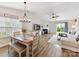Bright, open-concept living space with wood floors, fireplace, and dining area under chandelier at 2005 Grimley Ln, Fort Mill, SC 29707