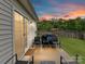 Back patio featuring outdoor seating and a beautiful sunset view, perfect for relaxing or entertaining guests at 2005 Grimley Ln, Fort Mill, SC 29707