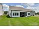 White siding home featuring a covered patio and a well-maintained green lawn at 2048 Turnsberry Dr, Monroe, NC 28112