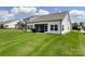 Home featuring a covered patio and a well-maintained green lawn with neighboring houses nearby at 2048 Turnsberry Dr, Monroe, NC 28112