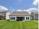 Home featuring a covered patio, well-maintained lawn, and neighboring houses at 2048 Turnsberry Dr, Monroe, NC 28112