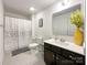 Well-lit bathroom with a modern vanity, a large mirror, and a stylish shower curtain, providing a fresh and clean feel at 2048 Turnsberry Dr, Monroe, NC 28112