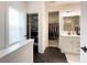 Bright bathroom featuring black hexagon tiles and access to both a closet and a walk-in wardrobe at 2048 Turnsberry Dr, Monroe, NC 28112