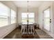 Charming breakfast nook features a round table, lots of natural light, and a view to the outside at 2048 Turnsberry Dr, Monroe, NC 28112