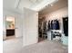 Spacious closet featuring custom shelving and rack systems for optimal organization, adjacent to a modern bathroom at 2048 Turnsberry Dr, Monroe, NC 28112