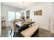 Dining room features a wooden table, a large window, and a decorative chandelier at 2048 Turnsberry Dr, Monroe, NC 28112