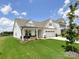 Inviting home with a spacious two-car garage, a welcoming front porch, and a beautifully landscaped lawn at 2048 Turnsberry Dr, Monroe, NC 28112