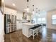 Spacious kitchen featuring a large central island with seating, stainless steel appliances, and ample cabinetry at 2048 Turnsberry Dr, Monroe, NC 28112