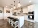 Modern kitchen featuring a large island with seating, stainless steel appliances, and stylish pendant lighting at 2048 Turnsberry Dr, Monroe, NC 28112