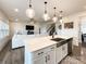 Bright kitchen features quartz countertops, stainless steel appliances, and opens to a living area at 2048 Turnsberry Dr, Monroe, NC 28112
