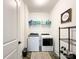 Well-lit laundry room featuring modern appliances, tiled floor, and ample storage space at 2048 Turnsberry Dr, Monroe, NC 28112