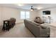Comfortable living room with a TV, a ceiling fan, and ample seating, creating an inviting space for relaxation and entertainment at 2048 Turnsberry Dr, Monroe, NC 28112