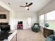 Home office with natural light and functional work space, complete with a TV, globe and recliner for relaxation and entertainment at 2048 Turnsberry Dr, Monroe, NC 28112