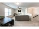 Bright living room with natural light, a comfortable sofa, and tasteful decor, ideal for relaxing and entertaining guests at 2048 Turnsberry Dr, Monroe, NC 28112