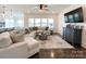 Spacious living room with lots of natural light, a ceiling fan, and a wall mounted television at 2048 Turnsberry Dr, Monroe, NC 28112