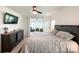 Spacious main bedroom features a ceiling fan, wall-mounted TV, and access to another room at 2048 Turnsberry Dr, Monroe, NC 28112