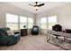 Bright and airy home office featuring large windows, comfortable seating, and a functional desk space for productivity at 2048 Turnsberry Dr, Monroe, NC 28112