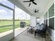 Screened porch featuring outdoor seating, ceiling fans, and views of a fenced green lawn at 2048 Turnsberry Dr, Monroe, NC 28112